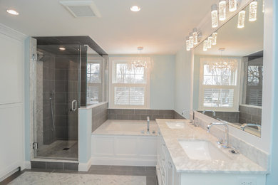 Design ideas for a large transitional master bathroom in Boston with beaded inset cabinets, white cabinets, an undermount tub, a corner shower, a two-piece toilet, gray tile, cement tile, blue walls, marble floors, an undermount sink, marble benchtops, white floor, a hinged shower door and white benchtops.