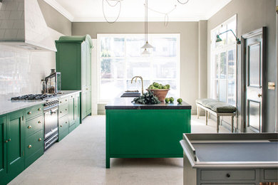 Inspiration for a medium sized kitchen with a double-bowl sink, green cabinets, white splashback, ceramic splashback, black appliances, an island, beige floors and green worktops.