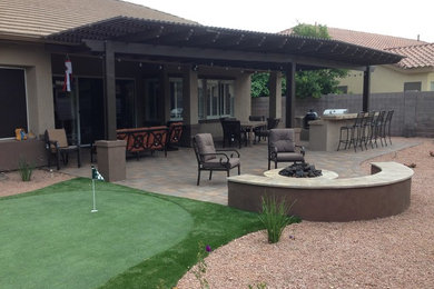 Inspiration for a mid-sized drought-tolerant backyard concrete paver landscaping in Phoenix.
