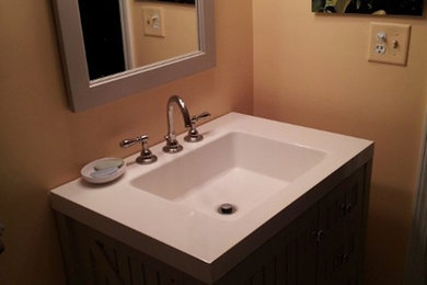 Example of a mid-sized classic 3/4 bathroom design in Chicago with shaker cabinets, dark wood cabinets, a one-piece toilet, beige walls, an integrated sink and solid surface countertops