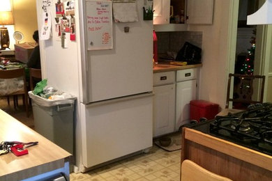 Enclosed kitchen - small transitional u-shaped vinyl floor enclosed kitchen idea in St Louis with an undermount sink, flat-panel cabinets, medium tone wood cabinets, granite countertops, yellow backsplash, ceramic backsplash, stainless steel appliances and a peninsula