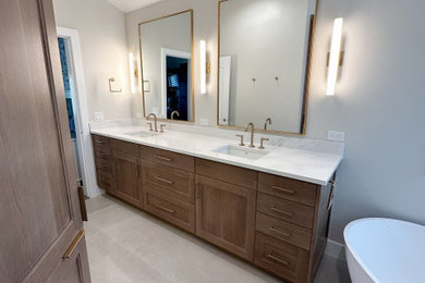 Bathroom - mid-sized modern master porcelain tile double-sink bathroom idea in Salt Lake City with flat-panel cabinets, medium tone wood cabinets, quartz countertops, a hinged shower door, white countertops and a built-in vanity