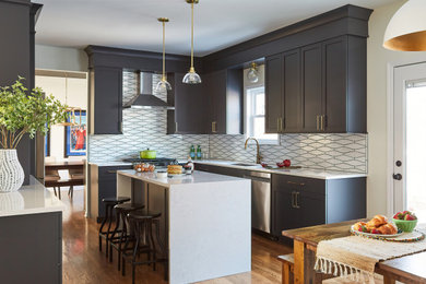 Inspiration for a large transitional medium tone wood floor and brown floor eat-in kitchen remodel in Chicago with an undermount sink, blue cabinets, quartz countertops, white backsplash, ceramic backsplash, stainless steel appliances, an island and white countertops