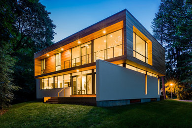 Example of a large minimalist white two-story mixed siding flat roof design in Boston