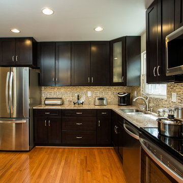 Espresso Kitchen Remodel with Granite Island and Stainless Steel Appliances