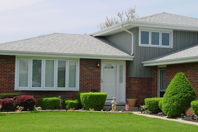 Inspiration for a mid-sized timeless two-story mixed siding exterior home remodel in Chicago with a hip roof