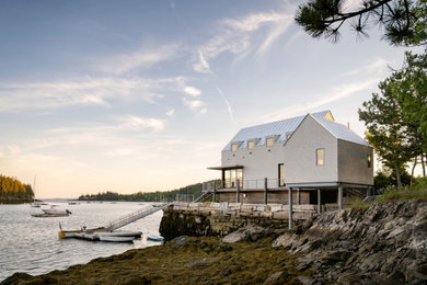 Example of a trendy two-story wood and shingle gable roof design in Other with a metal roof and a gray roof