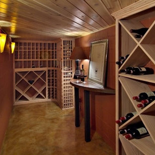 This is an example of a small contemporary fully buried basement in Minneapolis with concrete flooring and orange walls.