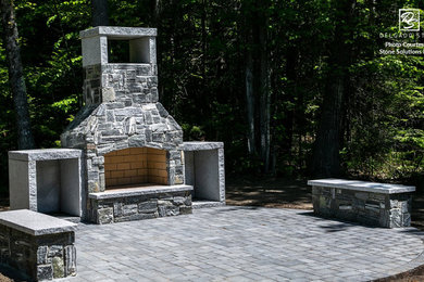 Inspiration for a mid-sized rustic backyard concrete paver patio remodel in Portland Maine with a fireplace