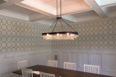 Example of a mid-sized trendy dark wood floor and brown floor enclosed dining room design in San Diego with beige walls