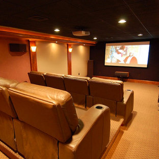 Mid-sized arts and crafts enclosed carpeted home theater photo in Providence with beige walls and a projector screen