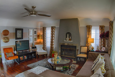 Inspiration for a timeless open concept laminate floor living room remodel in Los Angeles with gray walls, a standard fireplace, a stone fireplace and a tv stand