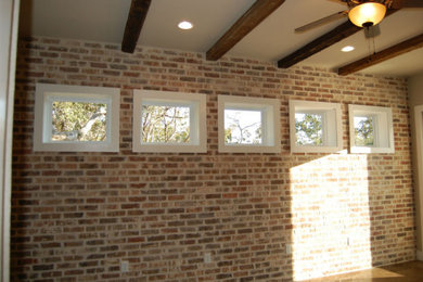 Bedroom - master brick wall bedroom idea in Austin