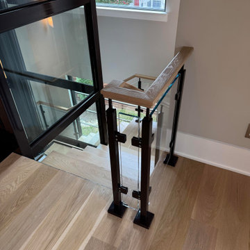 Project #136 | Modern Floating Staircase Encircling Glass Elevator