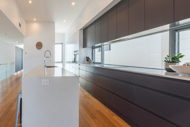 Inspiration for a large contemporary single-wall eat-in kitchen in Newcastle - Maitland with flat-panel cabinets and with island.