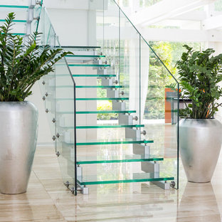 Medium sized contemporary glass u-shaped staircase in Saint Petersburg with open risers.