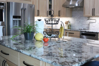 Inspiration for a large modern l-shaped eat-in kitchen remodel in Other with a double-bowl sink, granite countertops, multicolored backsplash, marble backsplash, stainless steel appliances, an island and multicolored countertops