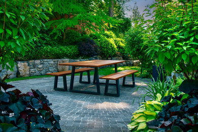 Inspiration for a coastal partial sun front yard brick and wood fence garden path in Vancouver for summer.