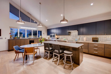 Eat-in kitchen - huge modern u-shaped medium tone wood floor and brown floor eat-in kitchen idea in Denver with an undermount sink, flat-panel cabinets, blue cabinets, quartz countertops, metallic backsplash, metal backsplash, stainless steel appliances, an island and white countertops