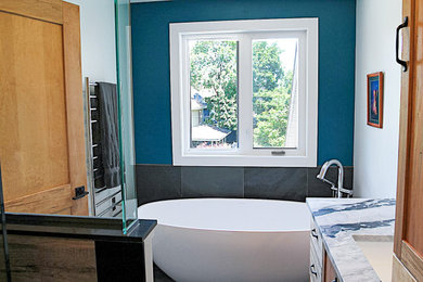 Trendy slate floor bathroom photo with blue walls