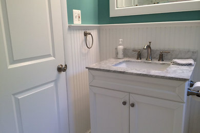 Mid-sized transitional 3/4 white tile and subway tile porcelain tile and white floor bathroom photo in DC Metro with recessed-panel cabinets, white cabinets, blue walls, an undermount sink and quartz countertops