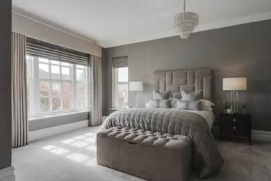 Design ideas for a large contemporary master and grey and silver bedroom in Cheshire with grey walls, carpet, no fireplace, grey floors, wallpapered walls and feature lighting.
