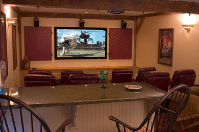 Example of a mid-sized mountain style enclosed carpeted and brown floor home theater design in Boston with a projector screen