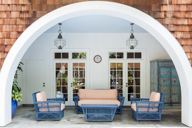 Beach style patio photo in Los Angeles with a roof extension