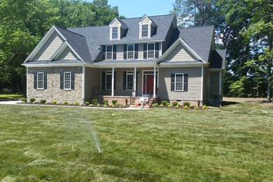 Mid-sized elegant gray three-story mixed siding exterior home photo in Other with a shingle roof