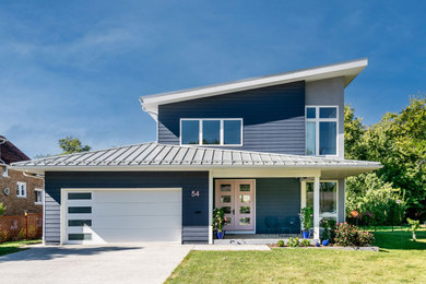 Minimalist blue two-story concrete fiberboard and clapboard house exterior photo in Chicago with a shed roof, a metal roof and a gray roof