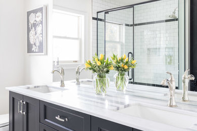 Double shower - huge contemporary master black and white tile and ceramic tile ceramic tile and white floor double shower idea in Toronto with beaded inset cabinets, black cabinets, a one-piece toilet, white walls, an undermount sink, marble countertops, a hinged shower door and white countertops