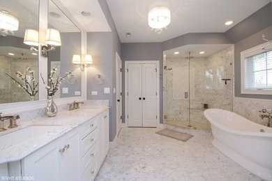 Transitional bathroom in Chicago with shaker cabinets, a freestanding tub and a corner shower.