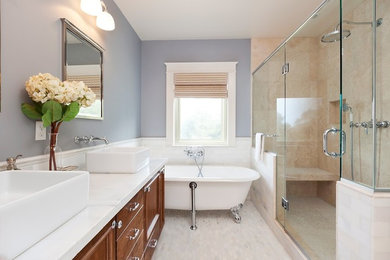 Inspiration for a large transitional master bathroom in Cleveland with recessed-panel cabinets, dark wood cabinets, a claw-foot tub, an alcove shower, a two-piece toilet, beige tile, stone tile, blue walls, mosaic tile floors, a vessel sink, quartzite benchtops, white floor and a hinged shower door.