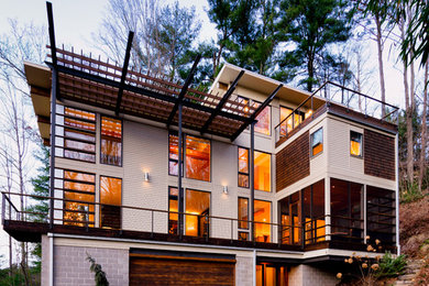Example of a trendy beige exterior home design in Raleigh