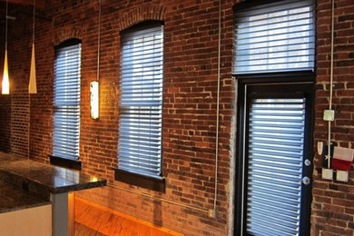 Inspiration for a large contemporary single-wall light wood floor eat-in kitchen remodel in Nashville with granite countertops and an island
