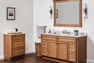 Inspiration for a mid-sized transitional master single-sink bathroom remodel with flat-panel cabinets, medium tone wood cabinets, an integrated sink, granite countertops, gray countertops and a freestanding vanity