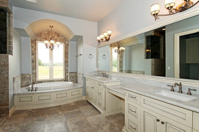 Large elegant master gray tile and stone tile bathroom photo in Other with an undermount sink, raised-panel cabinets, distressed cabinets, marble countertops and a two-piece toilet