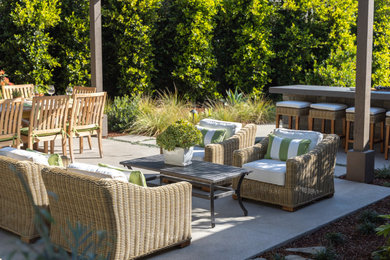 Inspiration for a coastal backyard concrete patio remodel in San Diego with a bbq area and a pergola