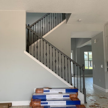 Gray staircase done with basket and double twist iron spindles