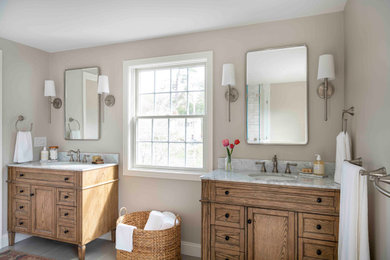 Large elegant master white tile and porcelain tile porcelain tile, gray floor and double-sink bathroom photo in Boston with recessed-panel cabinets, brown cabinets, a two-piece toilet, beige walls, an undermount sink, marble countertops, a hinged shower door, multicolored countertops and a freestanding vanity
