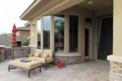 Example of a mid-sized tuscan beige one-story exterior home design in Phoenix