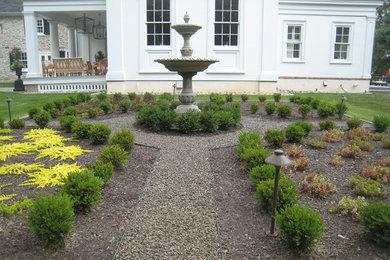 Large country backyard full sun formal garden in Philadelphia with a water feature and gravel for summer.