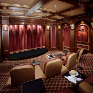 Photo of an expansive traditional enclosed home cinema in Charlotte with red walls, carpet and multi-coloured floors.