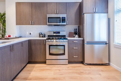 Inspiration for a kitchen remodel in Seattle with flat-panel cabinets and dark wood cabinets