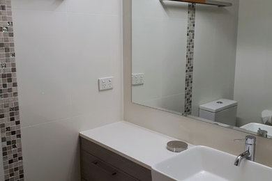 Design ideas for a small contemporary bathroom in Sunshine Coast with white tile, ceramic tile, white walls, cement tiles, grey floor and a sliding shower screen.