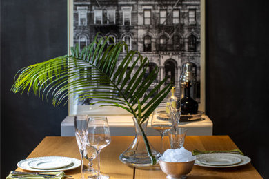 Example of a mid-sized dark wood floor and brown floor kitchen/dining room combo design in Toronto with black walls and no fireplace