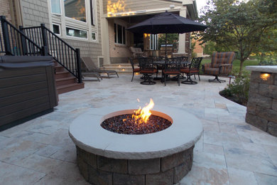 Example of a trendy backyard stone patio design in Cincinnati