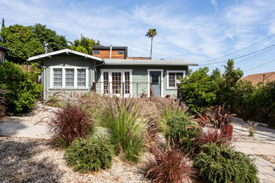 Mid-sized craftsman green one-story wood exterior home idea in Los Angeles with a shingle roof
