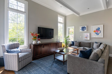 Example of a large transitional open concept dark wood floor, brown floor and exposed beam family room design in Chicago with a bar, gray walls and a wall-mounted tv