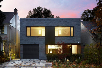 Inspiration for a mid-sized modern gray two-story brick exterior home remodel in Toronto
